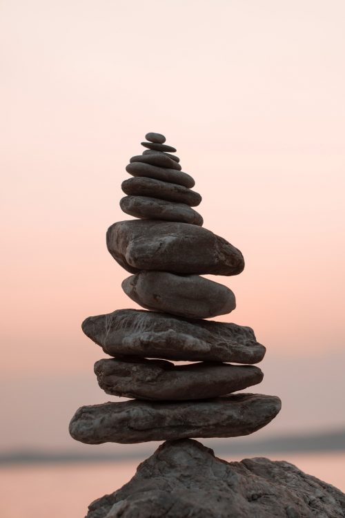 pile of triangular-shaped beach stones resembling temples or temples on jasmine beach, bali, indonesia