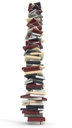 Towering stack of books isolated on white background.